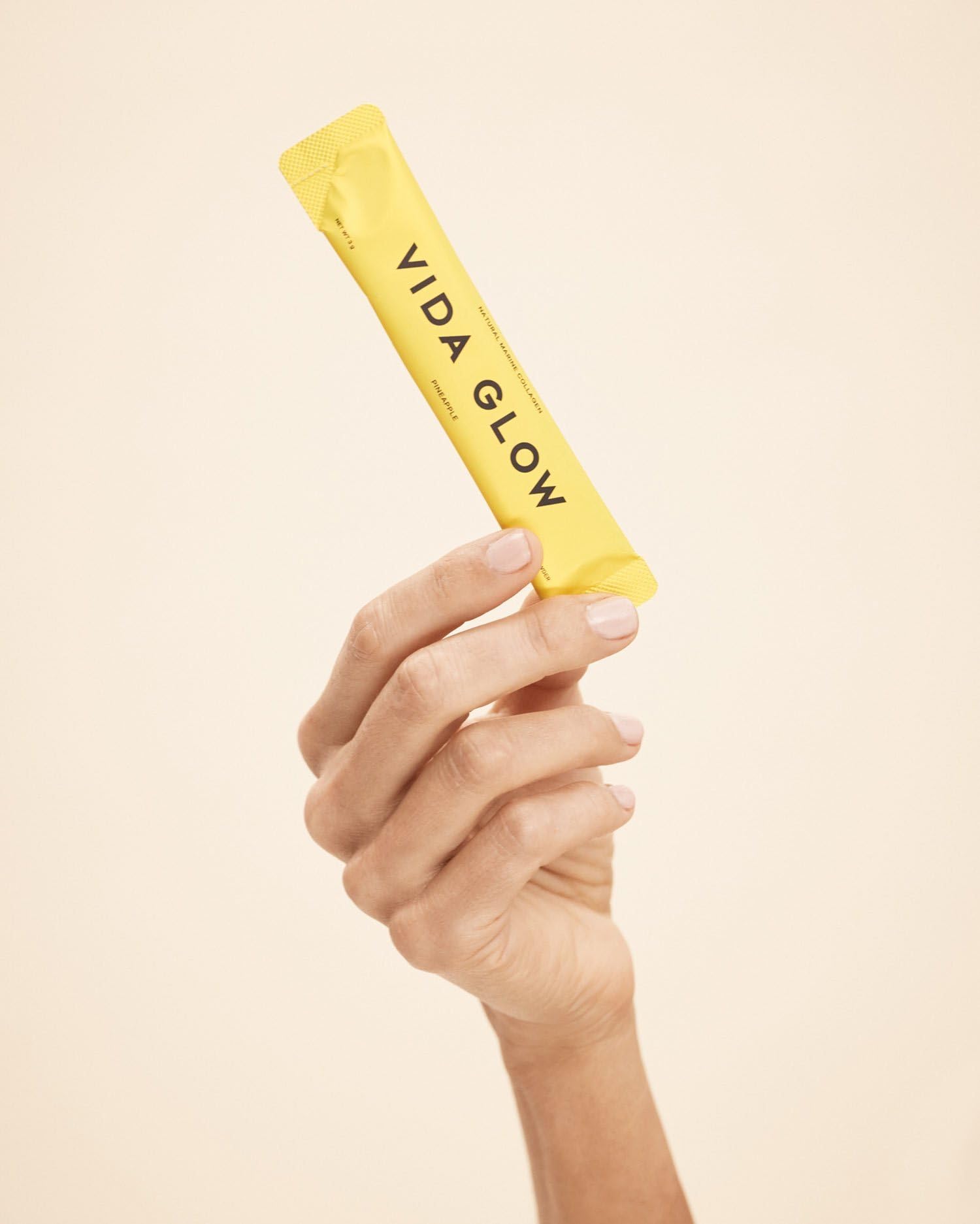 Vida Glow pineapple flavored powder in a glass demonstrates a refreshing hydration ritual.