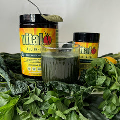 Spoon dipping Vital powder into water demonstrating quick mix