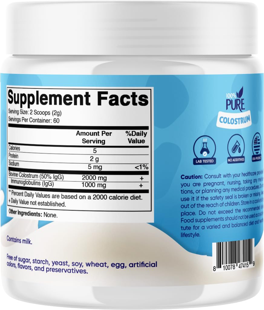 Vitamatic Bovine Colostrum Powder serving scoop beside a glass of smoothie