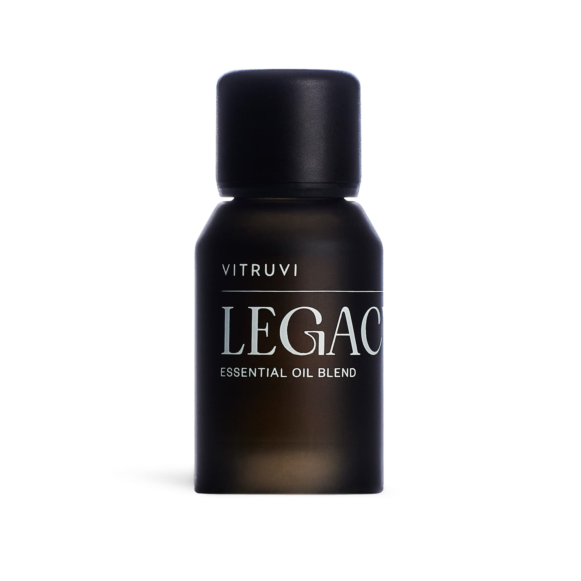 Vitruvi Legacy Woodsy Blend bottle highlights rose, bergamot, and cedarwood notes for calming diffusion.