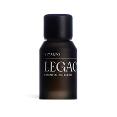 Vitruvi Legacy Woodsy Blend bottle highlights rose, bergamot, and cedarwood notes for calming diffusion.
