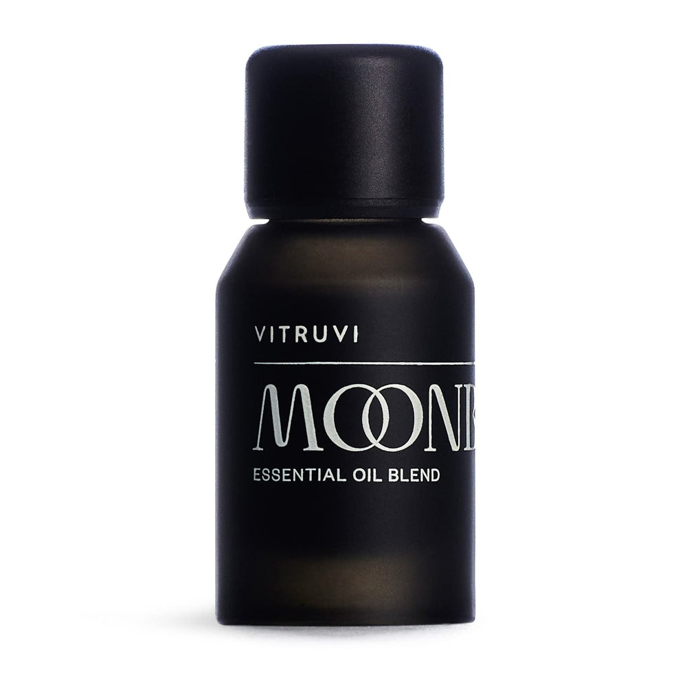 Vitruvi Moonbeam bottle on a wooden surface for a serene, fragrance-rich space.