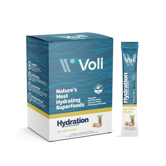Voli Electrolytes Pina Colada packets dissolving in water for refreshing hydration.