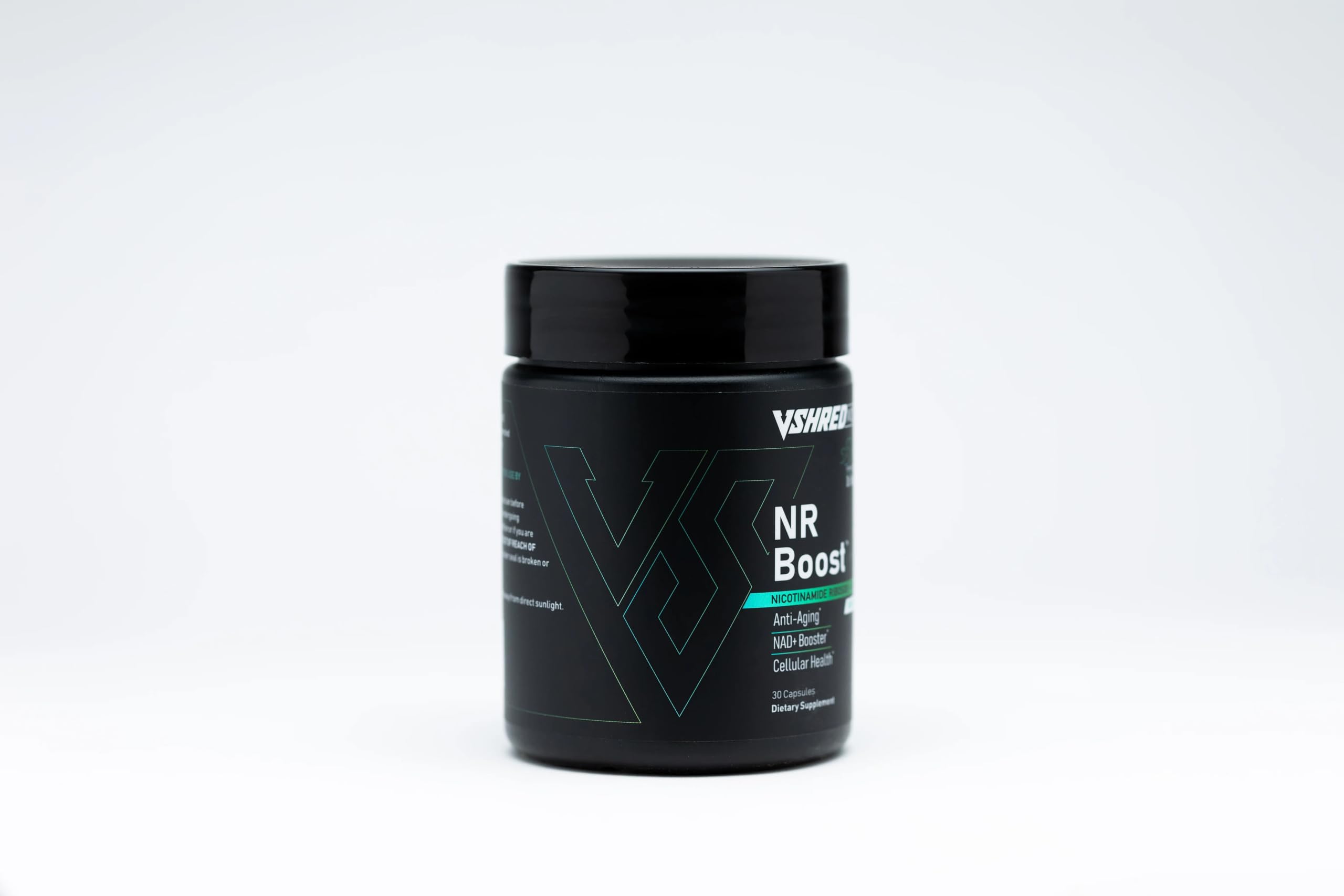 VShred MD NR Boost capsules resting with a glass of water, signaling daily wellness support.