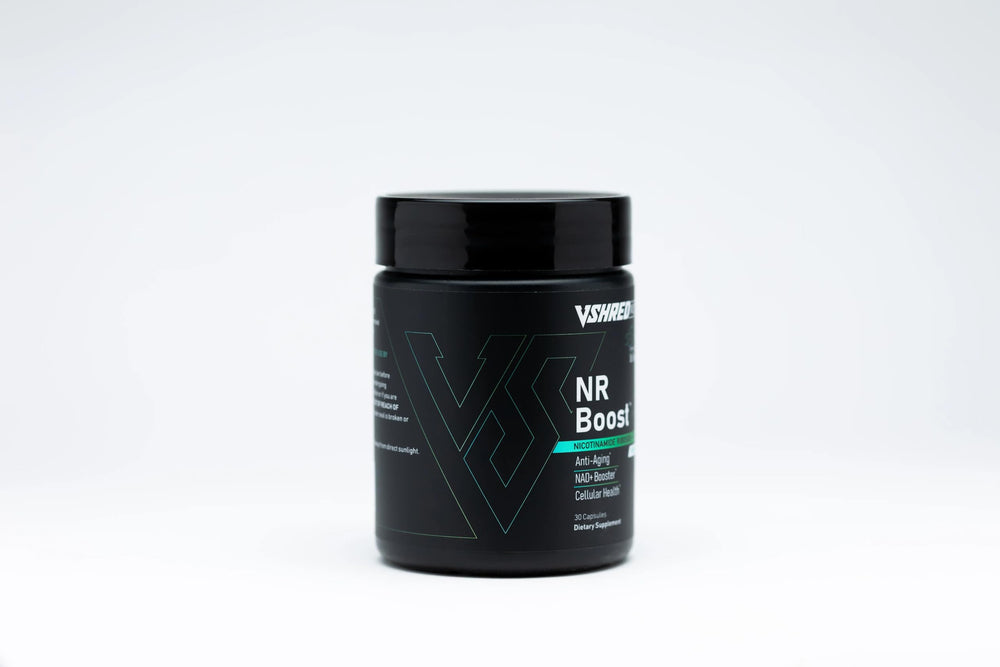 VShred MD NR Boost capsules resting with a glass of water, signaling daily wellness support.