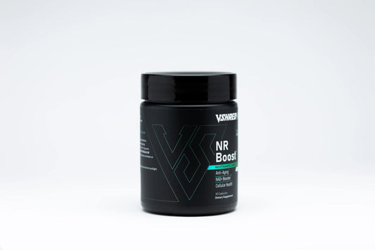 VShred MD NR Boost capsules resting with a glass of water, signaling daily wellness support.
