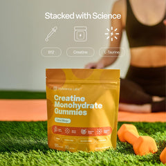 Gummies in hand showing chewy texture and color of citrus mango flavor