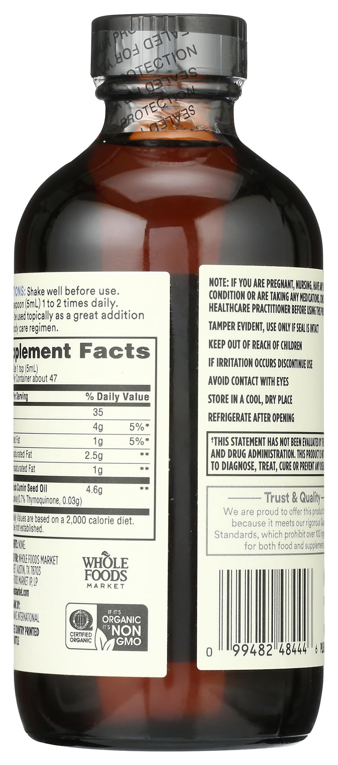 Whole Foods Market black seed oil bottle label showing ingredients and vegan, non-GMO quality
