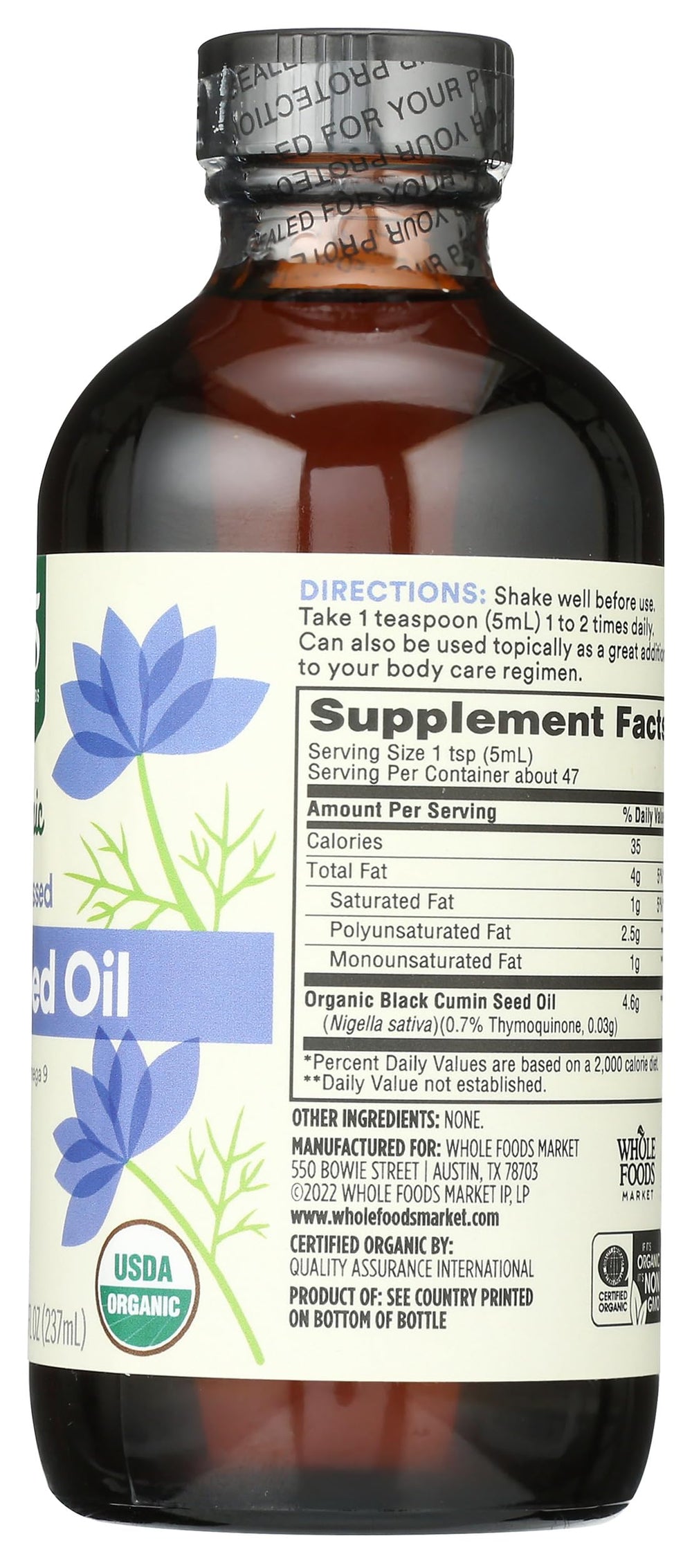 Whole Foods Market pouring black seed oil over spoon for easy daily supplementation