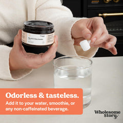 Wholesome Story powder poured into a cup, ready to mix a serving.
