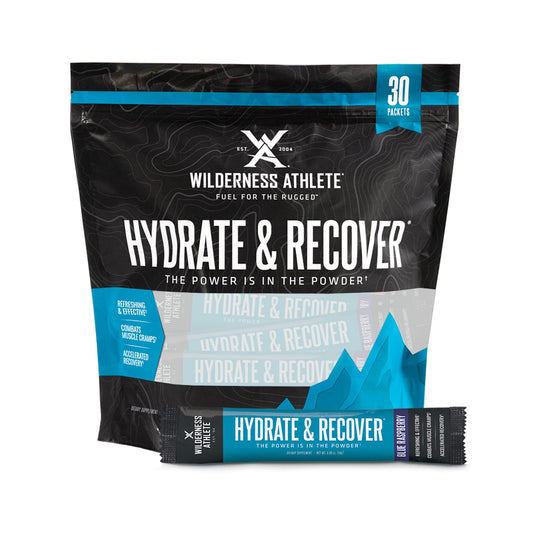 Wilderness Athlete Hydrate & Recover blue raspberry packets ready for hydration during workouts.