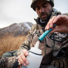 Wilderness Athlete grape hydration mix beside a shaker, ready for workout recovery.