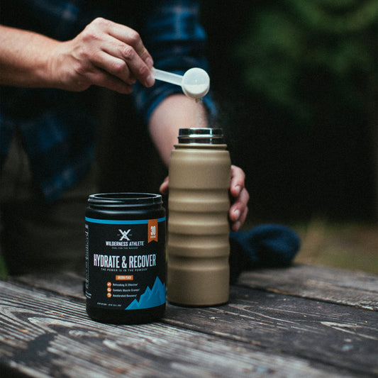 Close-up of Wilderness Athlete Hydrate & Recover powder being mixed.