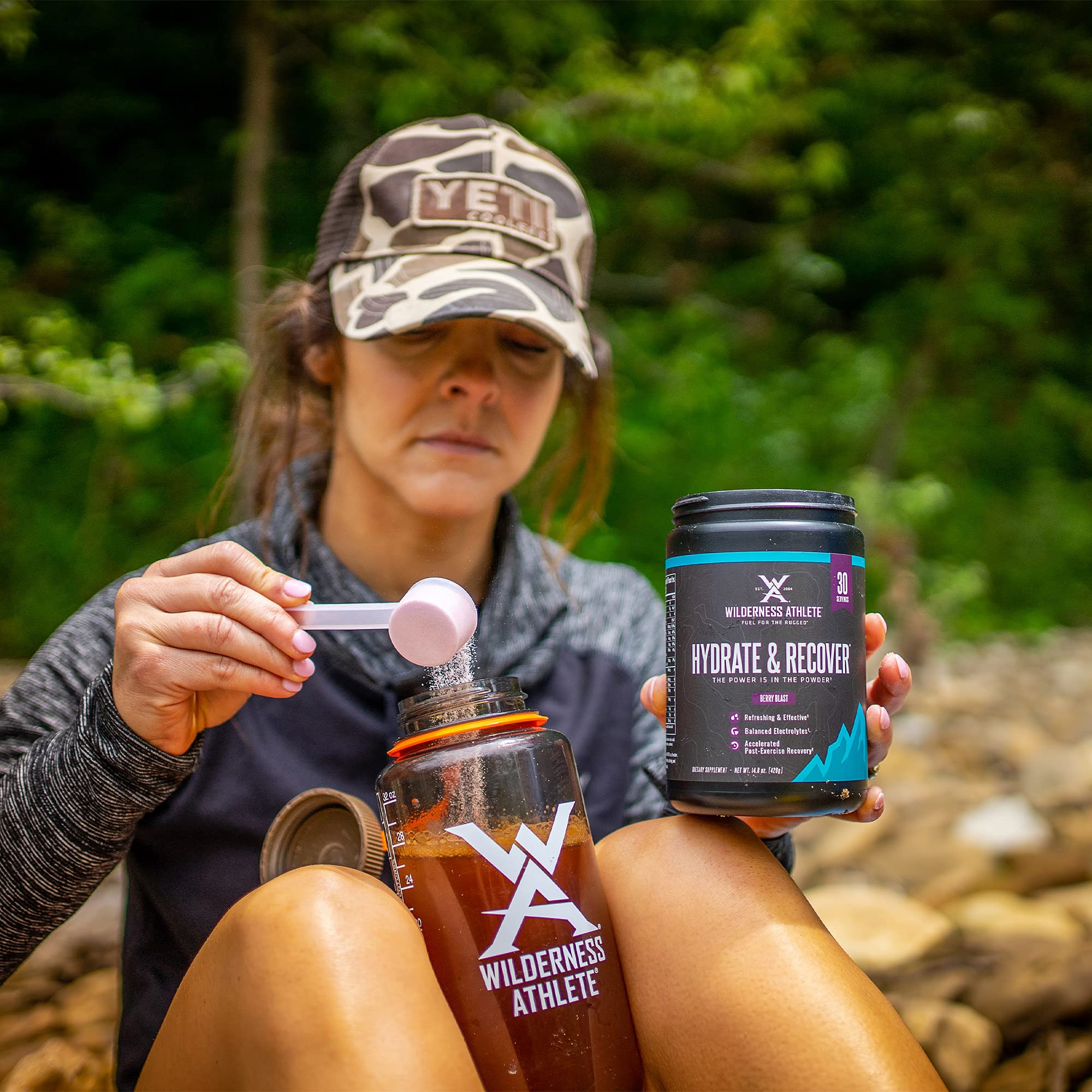 Wilderness Athlete Hydrate & Recover scoop demonstrates precise dosing for hydration.
