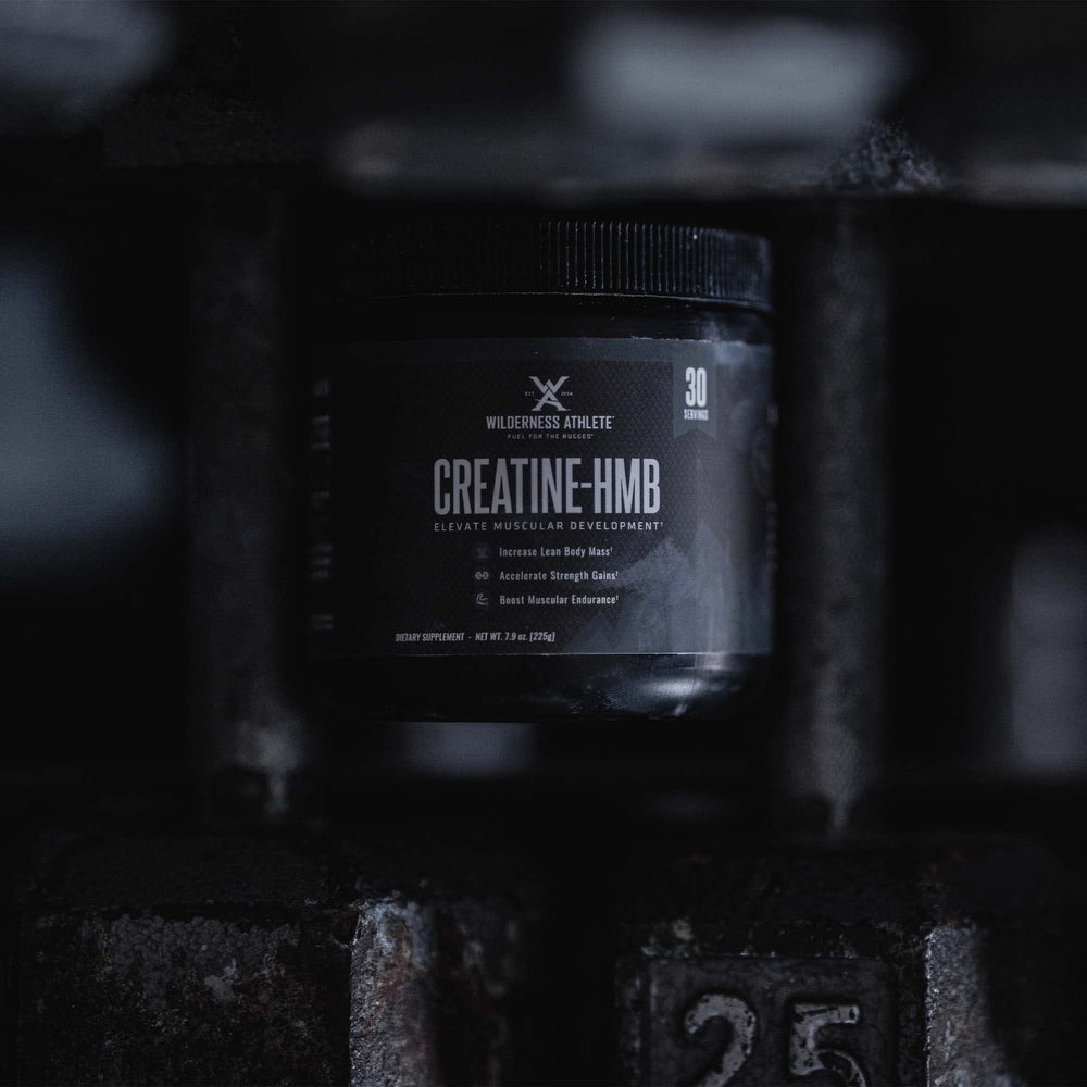 Scoop of Wilderness Athlete Creatine HMB powder ready for a shake.
