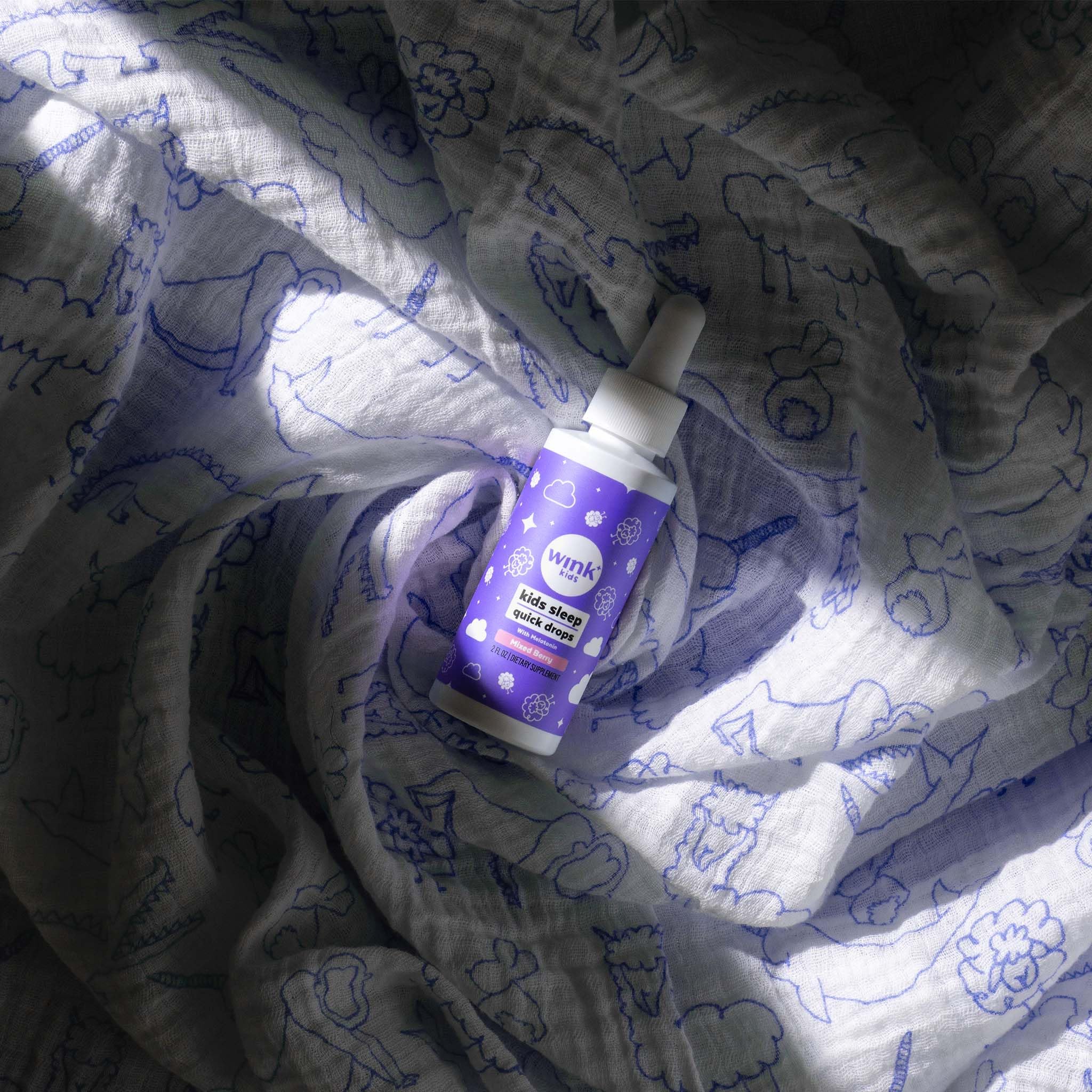 Wink Naturals WinkWell Kids Melatonin packaging on a nightstand