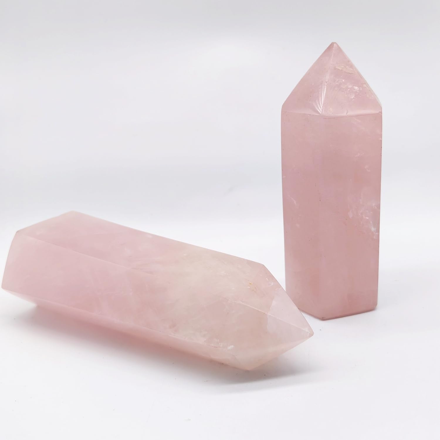 XMHOME rose quartz tower close-up facets reveal subtle ice cracks and translucence.