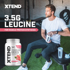Scoop of Xtend powder beside a jar, signaling easy mixability.