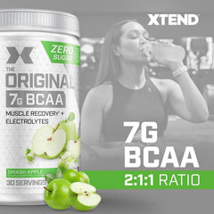 Xtend Original BCAA powder being poured into a shaker for hydration during training.