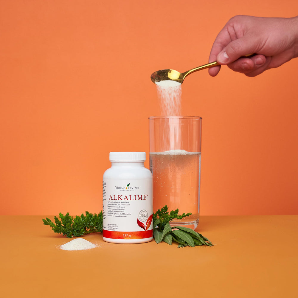 Young Living AlkaLime bottle pour showing easy mix into beverages.