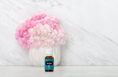 Young Living Marjoram bottle in a cozy self-care moment