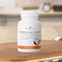 Young Living Super Cal Plus capsules displayed next to a dish for dosing context.