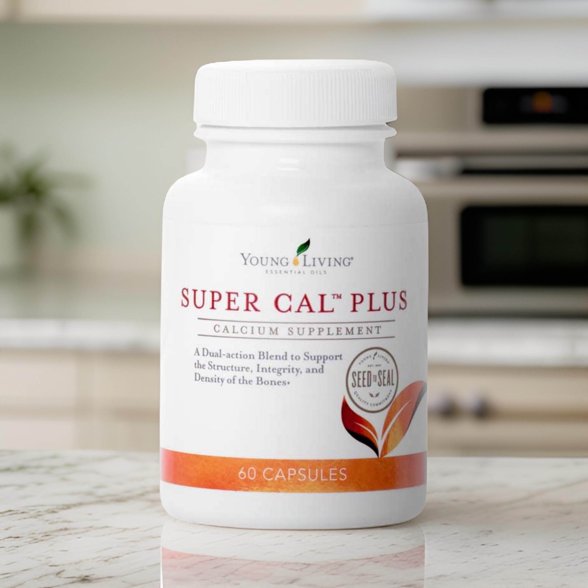 Young Living Super Cal Plus bottle viewed from the side in a clean setting.