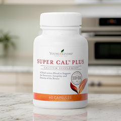 Young Living Super Cal Plus bottle viewed from the side in a clean setting.
