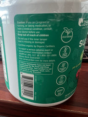 Spoonful of Zena Nutrition Greens powder dissolving in water for a quick, refreshing sip.